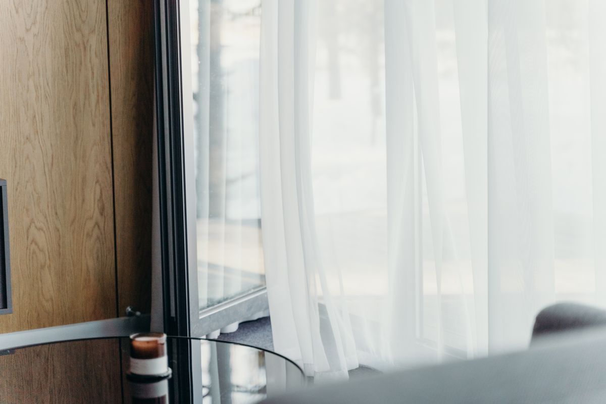 Soft daylight through sheer curtains in the private suite at The Capital 15 on Orange
